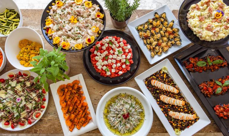 A colorful buffet with various fresh dishes, perfect for any occasion.